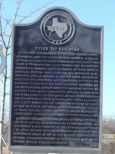 Tyler Tap Railroad Historic Marker in Tyler Texas ... route of the Cotton Belt: To provide for shipment of locally-grown fruits, vegetables, and cotton to distant markets, a group of Tyler citizens proposed a railroad to connect the town with major rail lines nearby. The promoters included R. B. Hubbard, later governor of Texas; James P. Douglas, onetime state senator; W. S. Herndon, A. M. Ferguson, and J. H. Brown. In 1871 the State Legislature accepted their proposal and chartered the Tyler Tap Railroad to join with the Texas & Pacific Railroad or the International & Great Northern Railroad within 40 miles of Tyler. Local organizers decided to link with the Texas & Pacific at Big Sandy. Actual construction was delayed until 1875, with the first train running Oct. 1, 1877. Funds for the tap line were to be secured by sale of stock, but when private financing failed to raise enough money, the Legislature agreed to award state land for each mile of track completed. Although organized and promoted by local citizens, the Tyler Tap line soon attracted other investors. In 1879, under a new charter, it was renamed the Texas & St. Louis Railway, with headquarters in Tyler. It was reorganized again in 1891 as the St. Louis Southwestern Railway, commonly known as the Cotton Belt, with general offices still located here.