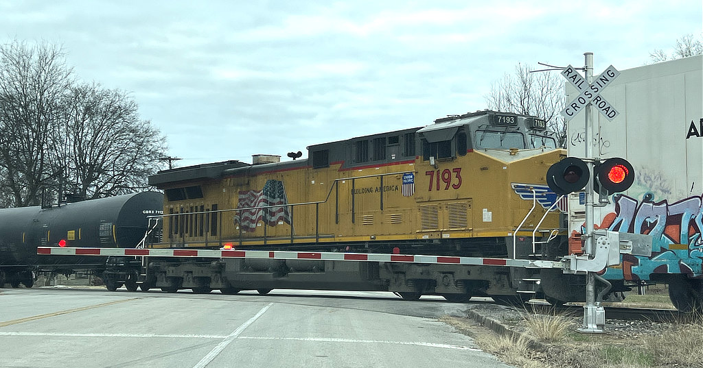 A westbound train being helped with Union Pacific 7193 at the West Houston Street crossing, Tyler, Texas - January 27, 2022